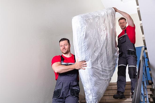 decluttering process involving the removal of a box spring in Parshall ND